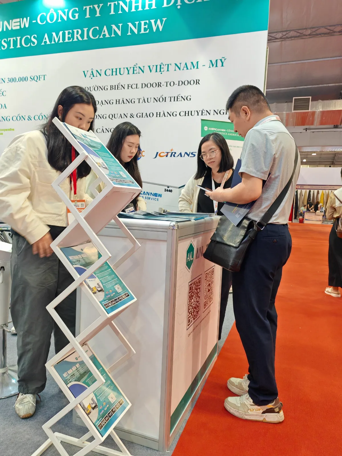 Discussing logistics at the booth