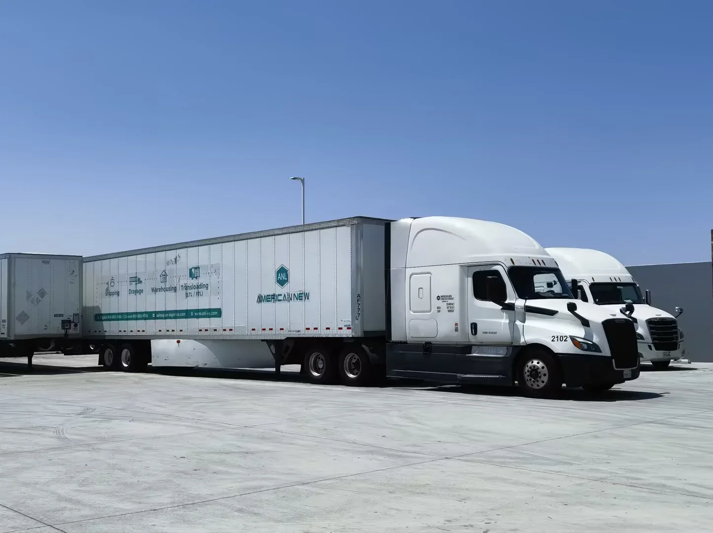 ANL trucks and trailers parked at a warehouse yard